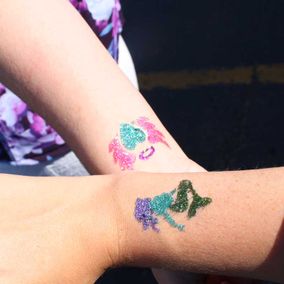 women showing their tattoo